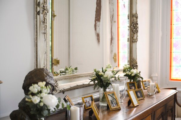 Photo frames on wooden table Victorian mirror and roses/flowers